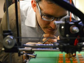 3D printer making tiny game pieces. (Postmedia Network file photo)