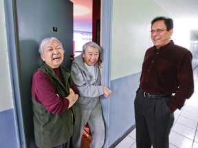 Gulu Thadani, landlord of 35 St. Dennis Dr. chats with tenants Nancy and her husband Joe Nakanishi in this 2013 file photo. Thadani says renovations have vastly improved his building. (ERNEST DOROSZUK/Tornoto Sun)
