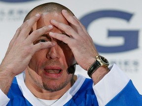 UFC welterweight champion Georges St. Pierre gestures as he speaks during a news conference at Les Galeries de la Capitale shopping centre in Quebec City, December 13, 2013. (REUTERS/Mathieu Belanger)