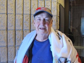 Kingston's Barry Holmes stands at the evacuation centre set up at Portsmouth Olympic Harbour with a blanket provided by the Red Cross. The Legion Villa resident is homeless after the building was damaged in Tuesday's fire at a nearby building.