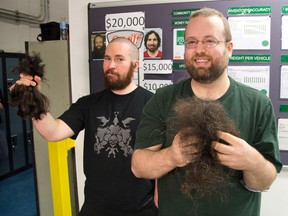 Brandon Beacom, left, holds his hair while Guy Laplante holds his beard after the two were sheared at Qualtech Seating in London Wednesday. The two pledged to shave if their Qualtech co-workers reached their $20,000 fundraising goal. The company raised $24,000 for the Business Cares Food Drive. Beacom is also donating his hair to Locks of Love, a charity that provides hairpieces to children suffering long-term medical hair loss from any diagnosis. DEREK RUTTAN/The London Free Press