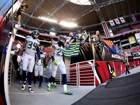 Cornerback Brandon Browner #39 and cornerback Richard Sherman #25 of the Seattle Seahawks take the field before a game against the Arizona Cardinals at the University of Phoenix Stadium on October 17, 2013 in Glendale, Arizona. (Christian Petersen/Getty Images/AFP)