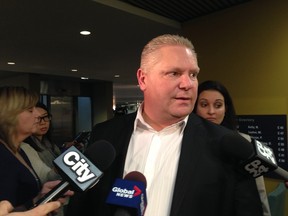Councillor Doug Ford speaks to reporters at Toronto City Hall on Dec. 19, 2013. (Don Peat/Toronto Sun)