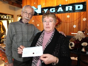 Pat Chapdelaine (left), executive vice-president of operations and technical design for Nygard International, presents a cheque to Kai Madsen, Christmas Cheer Board executive director, at the Nygard offices on Inkster Boulevard on Thu., Dec. 19, 2013. Winnipeg Sun/QMI Agency