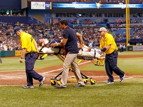 Pitcher Alex Cobb of the Tampa Bay Rays is taken off the field by medical personel after he was hit in the head by a line drive during a game against the Kansas City Royals at Tropicana Field on June 15, 2013. (J. Meric/Getty Images/AFP)