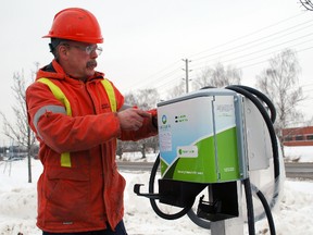 Dave Berger, an electrician for Ascent Group Inc., tightens bolts on the first public electric vehicle charging station in St. Thomas and Elgin county. The station was installed Thursday outside the Edward St. headquarters of St. Thomas Energy, a division of Ascent. The station will offer free charges to the public and can accommodate one car at a time. Ascent is set to officially launch the station Friday morning. Ben Forrest/Times-Journal