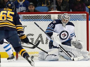 Dec 17, 2013; Buffalo, NY, USA; Winnipeg Jets goalie Ondrej Pavelec (31) makes a save on Buffalo Sabres right wing Brian Flynn (65) during the first period at First Niagara Center. Mandatory Credit: Kevin Hoffman-USA TODAY Sports