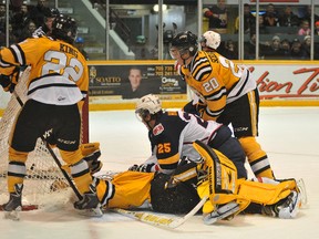 Barrie Colts forward Garret Hooey watches the puck go into the net while straddling Sarnia Sting goalie Taylor Dupuis for the Colts' second goal of the game in Ontario Hockey League action at the Barrie Molson Centre Thursday night. Barrie would beat the Sting 7-2. IAN MCINROY/BARRIE EXAMINER/QMI AGENCY