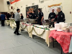 Cops flip pancakes for breakfast at McNally High School’s annual fundraiser for the Edmonton Sun’s Adopt-A-Teen Christmas Gift program. (Allison Salz photo)