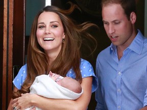 Britain's Prince William and his wife Catherine, Duchess of Cambridge, appear with their baby son Prince George outside the Lindo Wing of St Mary's Hospital, in central London on July 23, 2013. (REUTERS/Cathal McNaughton)