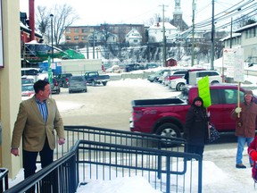 Kenora MP Greg Rickford leaves his Christmas open house at his Kenora office to say hello to the people protesting the government’s record of science and the environment outside.