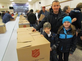 Mike Burr, with his children Tye Burr, 7, and Kami Burr, 10, joined other members of Local 663 of the steamfitters, plumbers and welders union pitching in to deliver 120 Christmas hampers Friday for the Salvation Army. Before the loading began at the Sarnia union hall, officials announced that Local 663's 19th annual fundraising campaign collected more than $58,000 this year for the Salvation Army. PAUL MORDEN/THE OBSERVER/QMI AGENCY