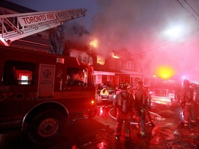 Fire crews battle a blaze on Laing St. on Friday. (JOHN HANLEY/Special to the Toronto Sun)