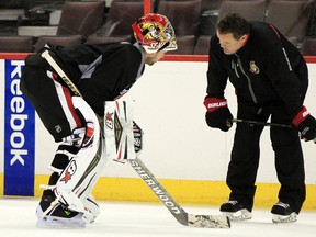 Craig Anderson, left, speaks with Senators goalie coach Rick Wamsley during practice Friday at the Canadian Tire Centre. Anderson will get the start today against the Coyotes.