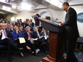 U.S. President Barack Obama and reporters react to his joke about the length of some of their questions during his year-end news conference in the White House Briefing Room in Washington, December 20, 2013.  REUTERS/Jonathan Ernst