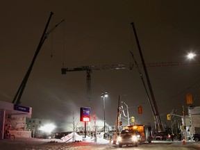 Workers begin the overnight process Friday night of dismantling the crane damaged in Tuesday's fire in midtown Kingston.
Elliot Ferguson The Whig-Standard