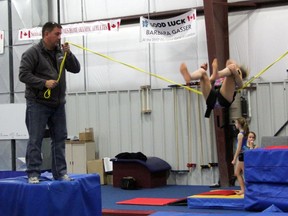 Bluewater Gymnastics Club coach Dave Brubaker helps students practice back tucks on Wednesday. SHAUN BISSON/THE OBSERVER/QMI AGENCY