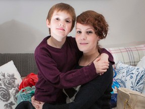 Seven-year-old Ayden Dent, with his mom Tanya Ouimet, has collected boots and shoes to donate to the Shepherds of Good Hope. Errol McGihon/Ottawa Sun/QMI Agency