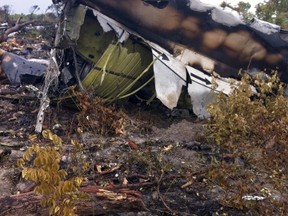 A handout picture released by the Namibian Transport Ministry shows the burnt wreckage of a Mozambican Airlines plane at the site of its crash in Namibia's Bwabwata National Park on November 30, 2013. (AFP PHOTO / HAFENI MWESHIXWA / TRANSPORT MINISTRY)