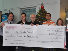The Canadian Science Centre for Human and Animal Health was pleased to present a cheque to the Christmas Cheer Board for over $14,000 Dec. 20, 2013. From left:  Greg McLean, Allan Lau, Kai Madsen, Ravinder Singh, Tamara Kruk and Rebecca Ladd. (HANDOUT)