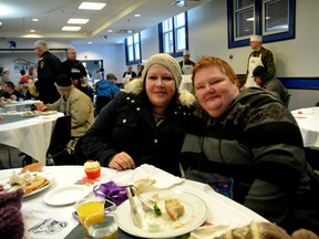 Shannon Amyotte, left, and Amy Allan enjoy Christmas dinner at the Ottawa Mission on Sunday afternoon. The Mission welcomes its residents and people in the community to join in on the feat every year. (Chris Hofley/Ottawa Sun).