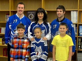 Students at école catholique Felix-Ricard pose with Sudbury Wolves forwards Connor Crisp and Mathew Campagna, as well as Anaina Mathieu, the youth financial adviser for Caisse populaire Les Voyageurs.  Photo supplied