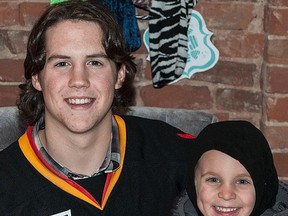 Belleville Bulls forward Jake Marchment visits with a young fan during a recent team event in downtown Belleville. (DON CARR For The Intelligencer)