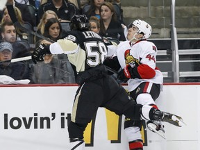 Ottawa Senators' Jean-Gabriel Pageau is checked by Pittsburgh Penguins' Kris Letang during NHL Eastern Conference Semifinal playoff hockey action at the Consol Energy Center in Pittsburgh, Pennsylvania on Friday May 24 ,2013. Errol McGihon/Ottawa Sun/QMI Agenc