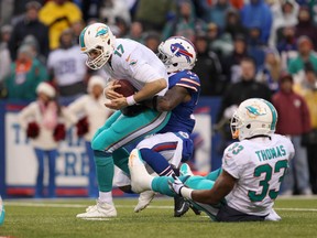 Bills defensive back Nickell Robey (37) sacks Dolphins quarterback Ryan Tannehill during second half action at Ralph Wilson Stadium on Sunday, Dec. 22, 2013. (Timothy T. Ludwig/USA TODAY Sports)