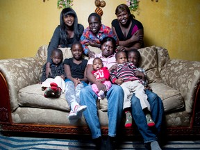 Abeny Kuol is relieved to be home with her family after managing a harrowing escape from South Sudan after warfare broke out in Juba, the city she was in working with the Sudanese Peoples Liberation Movement. She is surround by two of her five daughters Nyiel and Aluel (back row) along with Aluel's six children L to R Aduot (4), Joy (8), Kuol (11) Faith (5 moths), Isaiah (2), and Ateny (7). She was photographed in London, Ont. on Sunday December 22, 2013.DEREK RUTTAN/The London Free Press/QMI Agency
