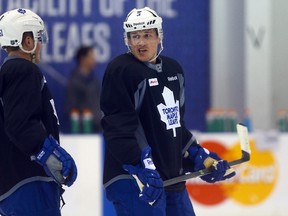 Jake Gardiner and Dion Phaneuf talk during Leafs practice at the Mastercard Centre on December 22, 2013. (Dave Abel/Toronto Sun/QMI Agency)