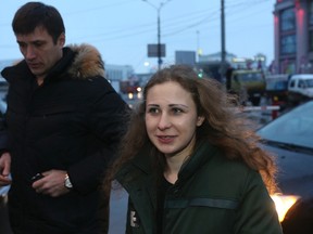 Maria Alyokhina, member of Russian punk band Pussy Riot, speaks to the media with her lawyer Pyotr Zaikin at a train station in Nizhny Novgorod December 23, 2013. (REUTERS/Sergei Karpukhin)