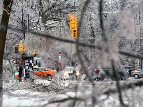 Ottawa Hydro workers will help make repairs after a major ice storm which left hundreds of thousands without power in the Greater Toronto Area, the Seaway corridor and parts of southern Ontario. This image is from the Royal York Rd. area in Toronto. (DAVE ABEL / Toronto Sun)