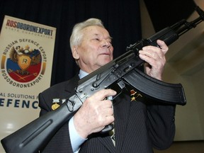 Mikhail Kalashnikov, chief designer of Izhmash Concern, a Russian firearms producer, poses with the latest model of his rifle during a news conference in Moscow in this April 15, 2006 file photo. (REUTERS/Sergei Karpukhin/Files)