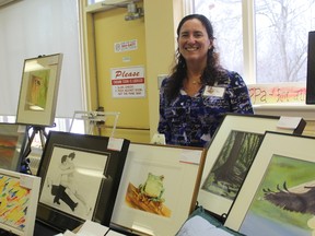 Organizer Sherri Cappa stands with a collection of her paintings on sale at the Winter Art-Mesphere art show at St. Aidan?s church.
