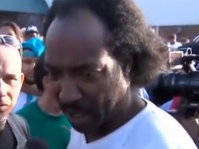 Charles Ramsey, right, speaks to a reporter in this video uploaded to YouTube. (YouTube screengrab)