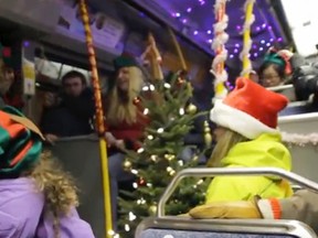 Passengers and students sing Christmas carols on an OC Transpo bus in this Christmas video created by Algonquin College students. (Screengrab via YouTube, AlgonquinTV)