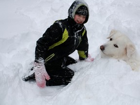 Columnist Barbara Wamboldt's grandson Grant plays with Pyrenees rescue dog, Samson. 
Submitted photo