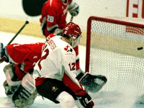 Brad Isbister (foreground), of Team Canada, watches the puck fly into the net while Oleg Orekhovski (L) and goalkeeper Radmir Faizov (C), of Russia, watch helplessly during their semi-final game at the 1997 World Junior Championships. Isbister and Sarnia Sting head coach Trevor Letowski won gold with Team Canada. OBSERVER FILE PHOTO