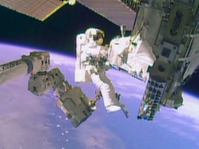 Astronaut Mike Hopkins works outside the International Space Station during a spacewalk, December 24, 2013, in this still image taken from video courtesy of NASA. (REUTERS/NASA/Handout)