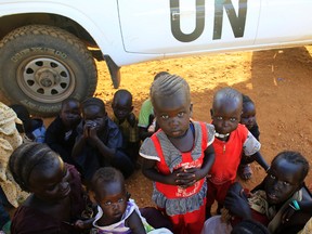 Newly arrived displaced families wait at Tomping United Nations base near Juba international airport, where some 12,000 people from the Nuer tribe have sought refuge at, December 24, 2013. (REUTERS/James Akena)