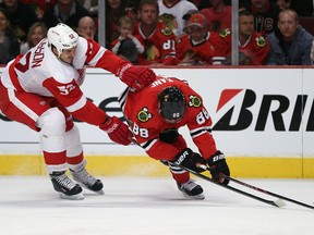 Jonathan Ericsson (left) of the Detroit Red Wings pushes Patrick Kane of the Chicago Blackhawks to the ice in Game Five of the Western Conference semifinals May 25, 2013 in Chicago. (Jonathan Daniel/Getty Images/AFP)