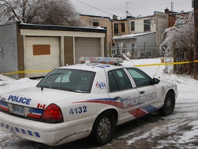 The home of a 54-year-old Scarborough man at Kingston Rd. and Sandown Ave., just west of Midland Ave., is guarded by Toronto Police Wednesday, Dec. 25, 2013. The man died in a vehicle fire on Christmas Day. (CHRIS DOUCETTE/TORONTO SUN)