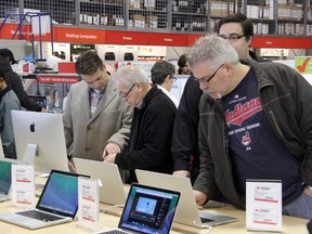 Mike Rawson (right) of Sarnia looks at Apple MacBook Pro's at the Boxing Day Sale at Future Shop. The store opened at 6am on Dec. 26, and deal seekers lined up around the outside of the store to get at the deals inside. SHAUN BISSON/THE OBSERVER/QMI AGENCY