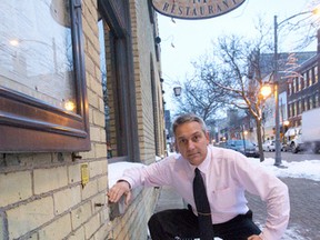 Jerry Pribil, owner of the Marienbad Restaurant, shows the spot where a copper dog statue was stolen. (CRAIG GLOVER, The London Free Press)
