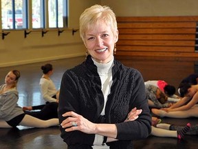 Marilyn Lawrie, executive director, Quinte Ballet School, is photographed here inside one of the dance studios at the Belleville school while a senior class loosen up for a session. JASON MILLER /The Intelligencer/QMI Agency