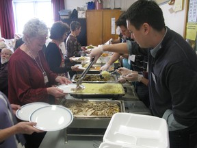 Volunteers prepare to dole out turkey dinners with all of the trimmings at St. Paul's Anglican Church on Christmas Day. (Peter Hendra/The Whig-Standard)