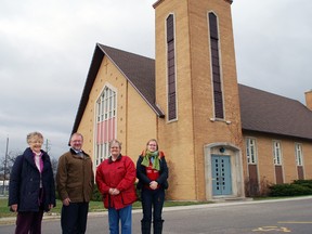 Parishioner Elaine Catchpole, left, Rev. Jim Evans and parishioners Margaret McKnight and Amy Nickson stand outside the future home of New Vision Community Church, in St. Thomas. New Vision will be created when the congregations of Grace United Church and St. Mark's United Church merge on Jan. 1. The new church will be housed in the current St. Mark's building.