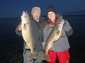 Chris Irwin, of Missouri, and Ashley Rae display some trophy walleye caught in the Bay of Quinte during a photo shoot on Dec. 13. (Supplied photo)