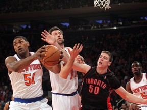 Knicks’ Metta World Peace (far left) and Andrea Bargnani fight for a rebound with Raptors’ power Tyler Hansbrough as New York’s Tim Hardaway Jr. looks on Friday night at Madison Square Garden. (USA TODAY SPORTS/PHOTO)